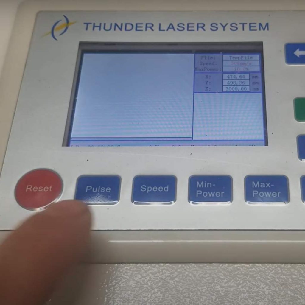 close up of the controller screen on a thunderlaser Nova series laser cutter. finger is about to press the Pulse button