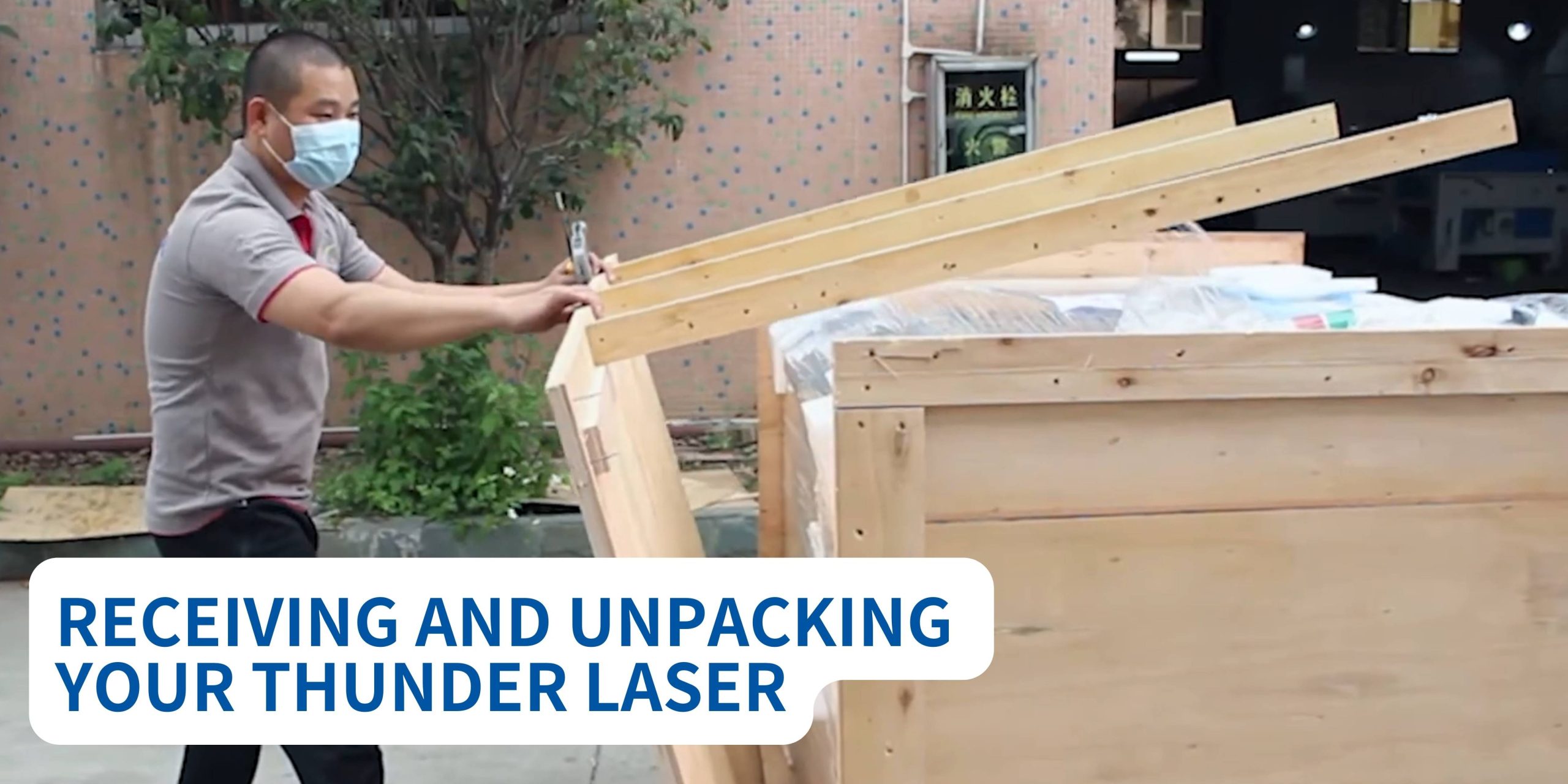 A MAN UNPACKING A WOODEN CRATE WITH A THUNDER LASER MACHINE INSIDE.TITLE READS RECEIVING AND UNPACKING YOUR THUNDER LASER