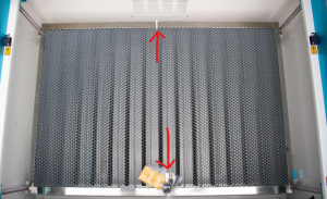 photo of laser bed with arrows drawn on top indicating location of cable ties at top and bottom of laser bed on a thunder laser machine