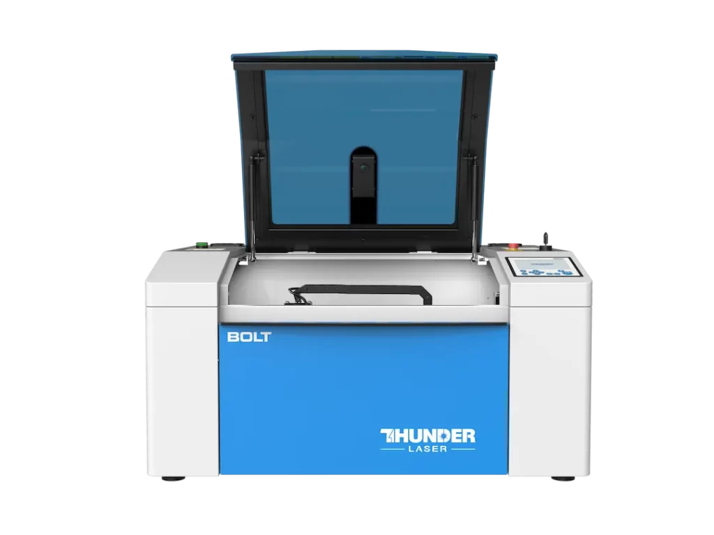 Thunder bolt laser cutter canada by thunder laser canada open lid on a desk. machine is blue and white