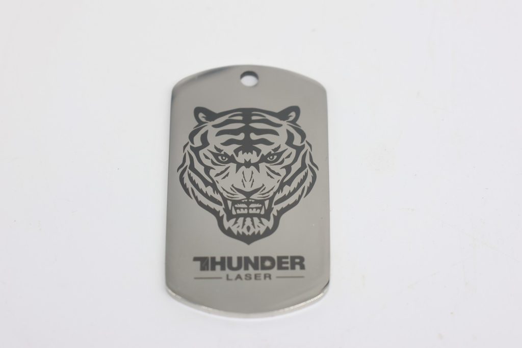 Metal tag with a tiger image with thunder laser logo made on a fiber laser engraver