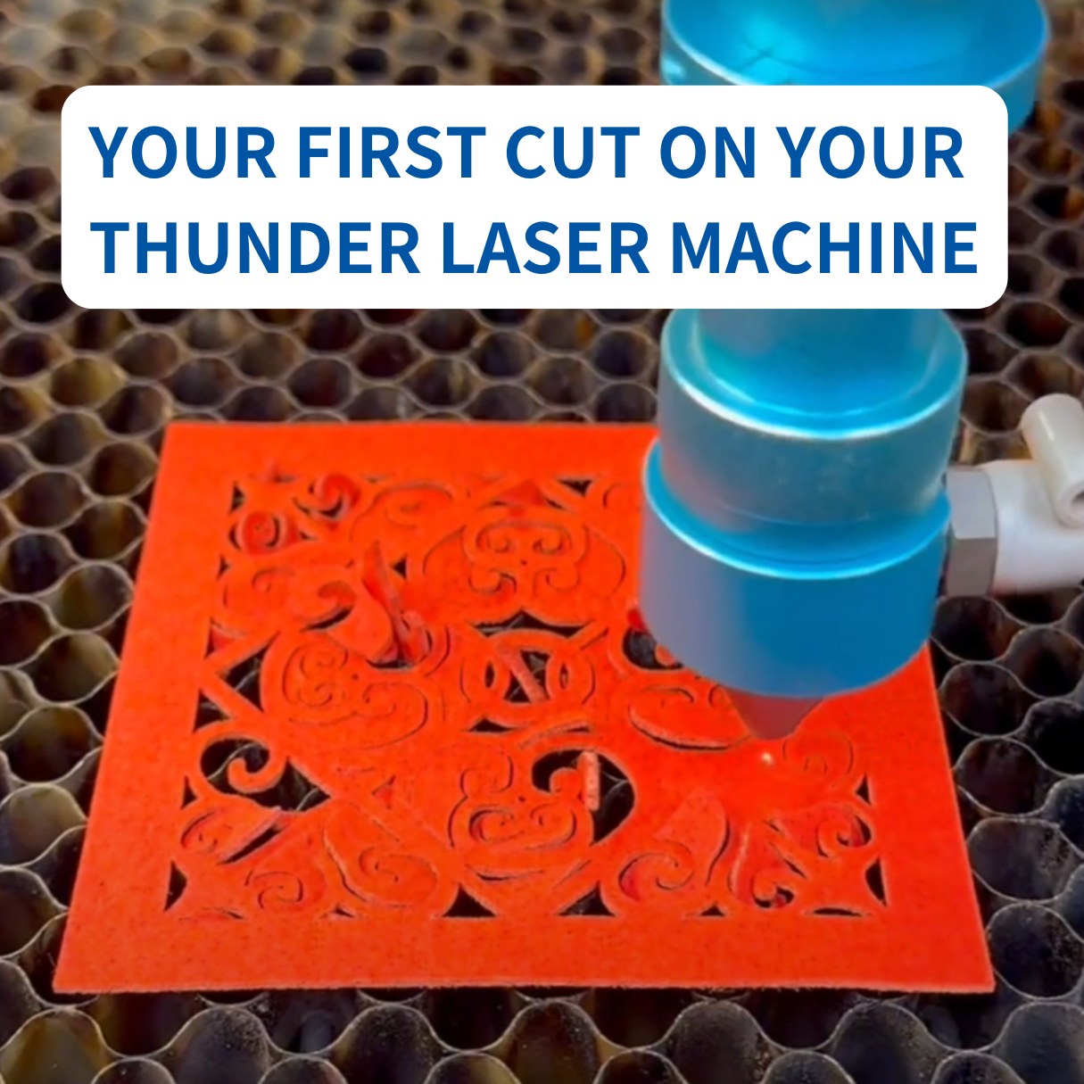 a close up image of thunder laser head cutting a red material into an intricate design like victorian brocade