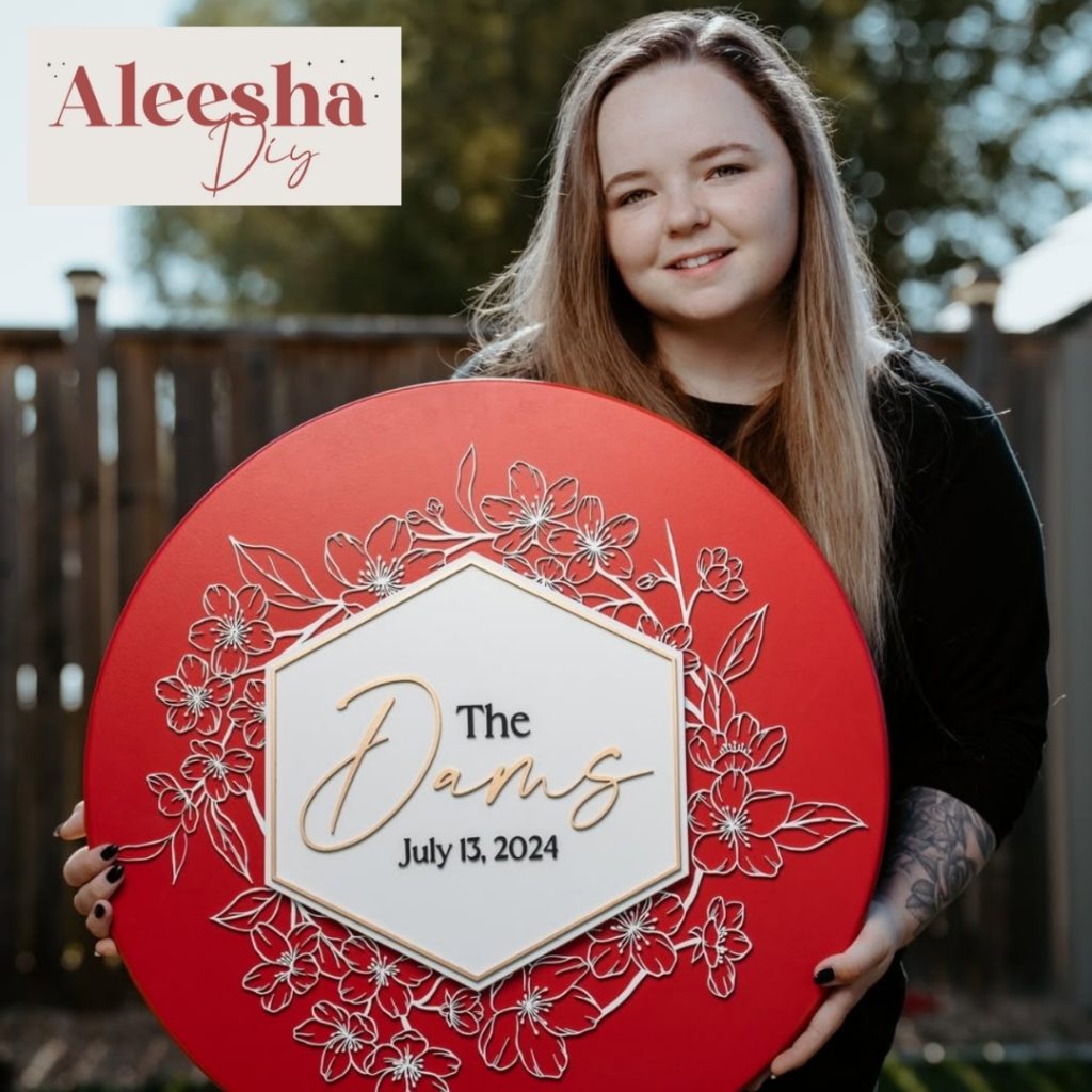 light skinned woman with long blond brown hair hlds a red sign with a with polygon in the center